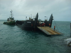 Barge docking with heavy equipment for island roadworkers